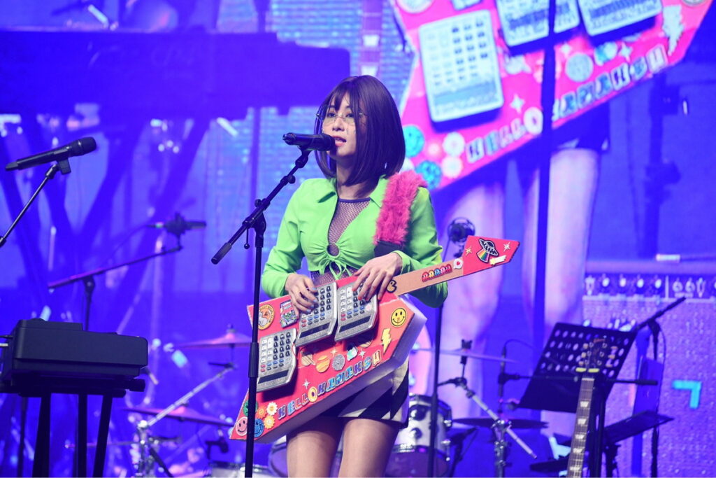照片說明：歌手徐小花，利用三台電子計算機，自製吉他演唱「愛的風波」。