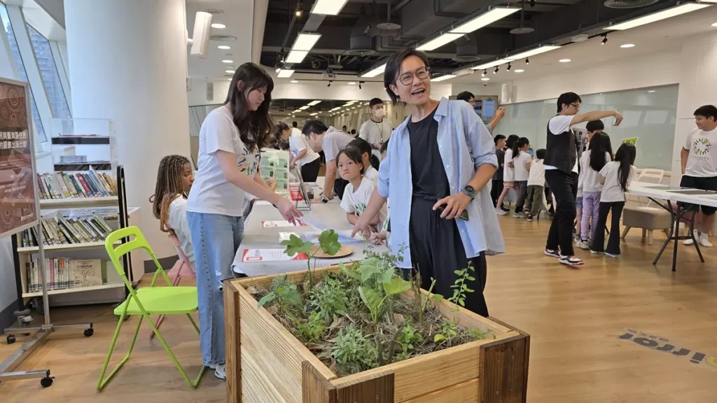 五權社大主帶老師王麗雅現場說明，由青少年同學、館員、五權社大學員共同手作完成4個高架省水菜箱的功能與內容，以及計畫初期教學先以知識為基礎，以及建構口袋花園實驗基地的堆肥材料室、高價菜箱種植可食食物。（圖/陳惠玲攝影）